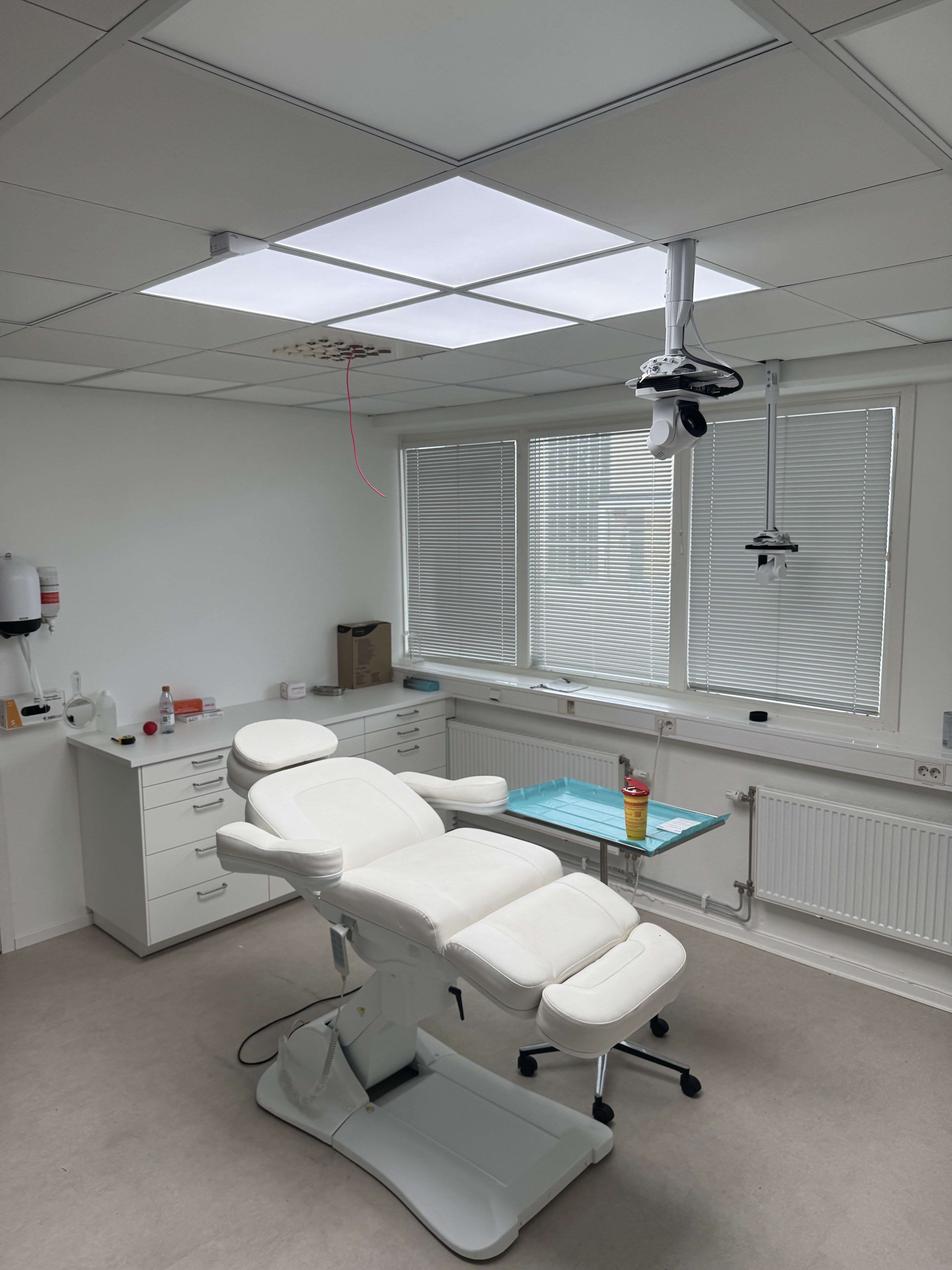 Clinical treatment room with a modern medical bed.